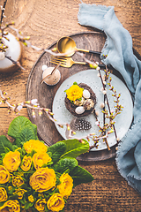 Image showing Easter table setting with spring flowers and cutlery on wooden table