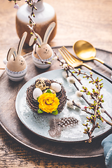 Image showing Easter table setting with spring flowers and cutlery on wooden table