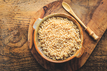 Image showing Healthy colorful cooked quinoa. Superfood, gluten-free food on wooden background