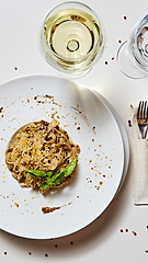 Image showing Tagliatelle with mushrooms and decorated with basil leaves.