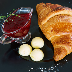 Image showing Closeup of butter, jam and fresh croissants