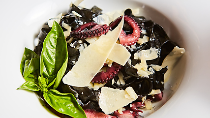 Image showing Pasta with black cuttlefish ink, octopuses and parmesan.