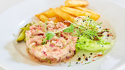 Image showing Meat tartar with french fries and vegetable salad.