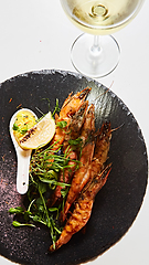 Image showing Grilled shrimp skewers. Seafood, shelfish. Shrimps Prawns skewers with herbs, garlic and lemon.