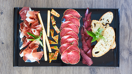 Image showing Antipasto Platter Cold meat plate with grissini breadsticks.