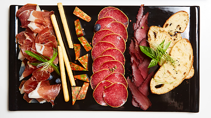 Image showing Antipasto Platter Cold meat plate with grissini breadsticks.