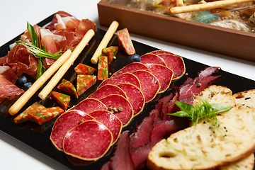 Image showing Antipasto Platter Cold meat plate with grissini breadsticks.