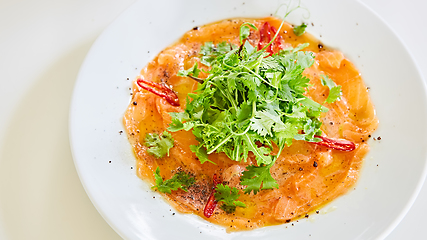 Image showing Top view of salmon carpaccio. Shallow dof.