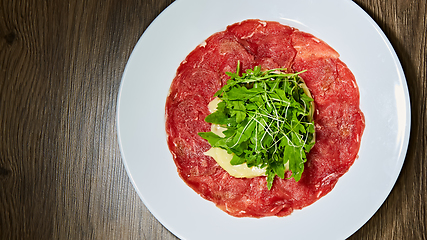 Image showing The meat carpaccio with salad. Shallow dof.