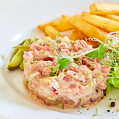 Image showing Meat tartar with french fries and vegetable salad.