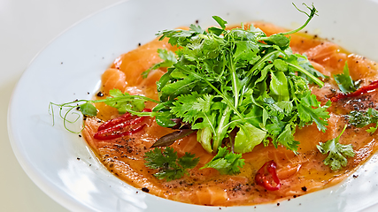 Image showing Top view of salmon carpaccio. Shallow dof.