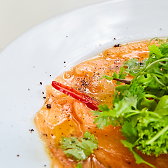 Image showing Top view of salmon carpaccio. Shallow dof.