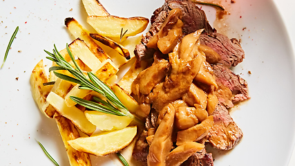 Image showing The potatoes fried with mushrooms and beef.