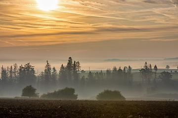 Image showing Autumn foggy and misty sunrise landscape