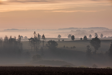 Image showing Autumn foggy and misty sunrise landscape