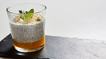 Image showing Mango yogurt with chia seeds for healthy breakfast on a white background