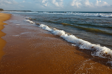 Image showing Wave surging on sand