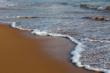 Image showing Wave surging on sand