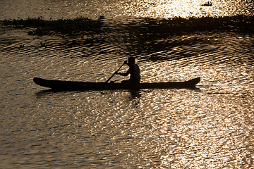 Image showing Man in canoe. Kerala backwaters, India