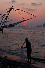 Image showing Fisherman and chinese fishnets on sunset. Kochi, Kerala, India