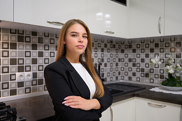 Image showing Young woman at luxury modern white kitchen interior in provence style