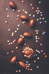 Image showing Sweet Easter - Chocolate eggs and colorful chocolate beans in bird nest