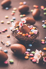 Image showing Sweet Easter - Chocolate eggs and colorful chocolate beans in bird nest