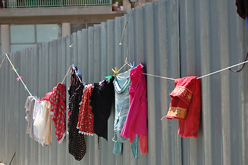 Image showing laundry drying on metal fence