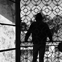 Image showing man on balcony of abandoned house