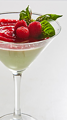 Image showing Delicious Italian dessert Panna Cotta with raspberry in small transparent glass