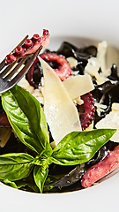 Image showing Pasta with black cuttlefish ink, octopuses and parmesan.