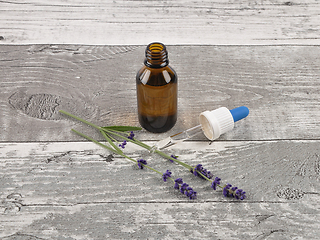 Image showing Lavender and essence on weathered wood