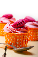 Image showing pink berry cream cupcake with macaroon on top