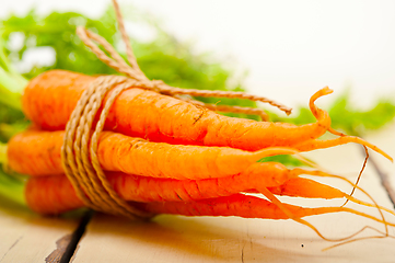 Image showing baby carrots bunch tied with rope