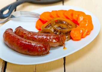 Image showing beef sausages cooked on iron skillet