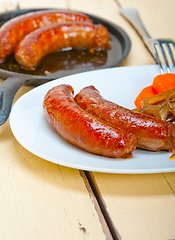 Image showing beef sausages cooked on iron skillet