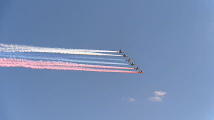 Image showing Stormtroopers planes Su-25 fly in sky leaving trail of smoke as tricolor Russian flag