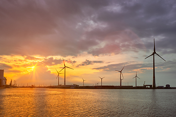 Image showing Wind turbines in Antwerp port on sunset.