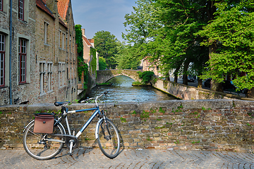 Image showing Bicyccle on a bridge near canal and old houses. Bruges Brugge , Belgium