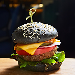 Image showing Japanese Black Burger with Cheese. Cheeseburger from Japan with black bun on dark background.