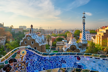 Image showing Barcelona city view from Guell Park. Sunrise view of colorful mosaic building in Park Guell