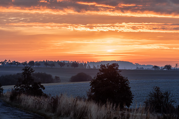 Image showing Autumn foggy and misty sunrise landscape