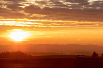 Image showing Autumn foggy and misty sunrise landscape