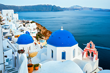 Image showing Famous view from viewpoint of Santorini Oia village with blue dome of greek orthodox Christian church