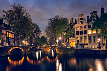 Image showing Amterdam canal, bridge and medieval houses in the evening