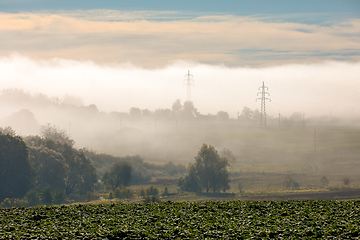 Image showing Fall foggy and misty sunrise landscape