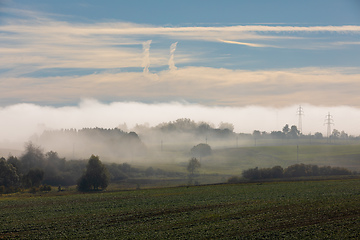 Image showing Fall foggy and misty sunrise landscape