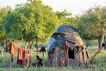 Image showing old himba woman in front of hut, Namibia Africa