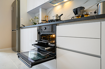 Image showing Open electric oven at white kitchen