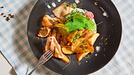 Image showing The grilled squid with salad. Shallow dof.